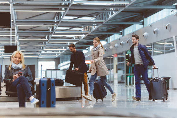 istock Passengers running towards boarding gate at airport 815720352