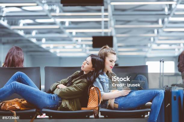 Female Travelers Waiting For Their Flight At Airport Lounge Stock Photo - Download Image Now