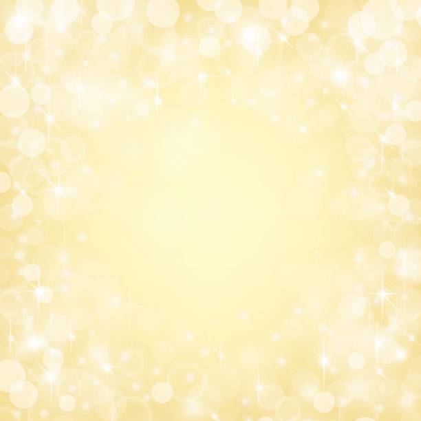 istock Shiny bokeh lights, stars and sparkles on golden background. 815730878