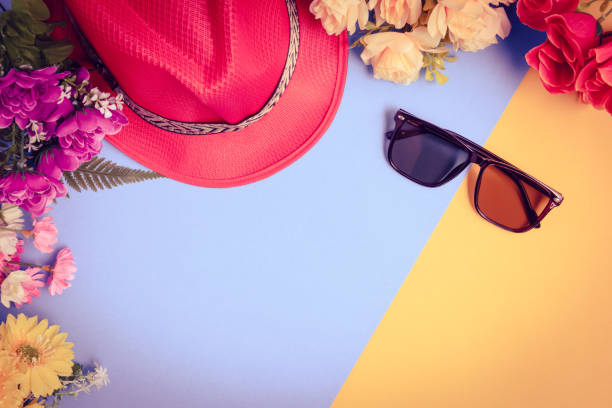 istock Flat lay hat and sunglasses with flowers on top table 815735050