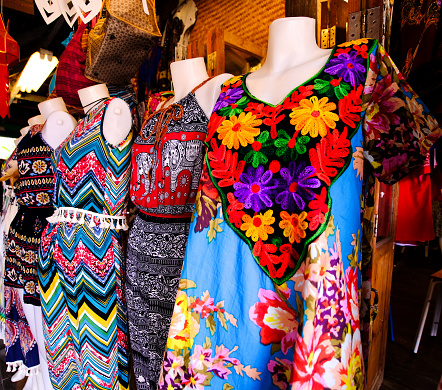 Colorful dresses for sale in one of many booths in the Floatmarket in Pattaya, Thailand.