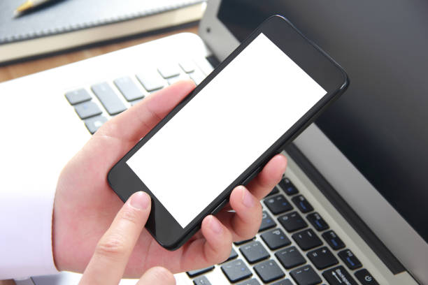istock Female hand holding blank mobile phone 815740704