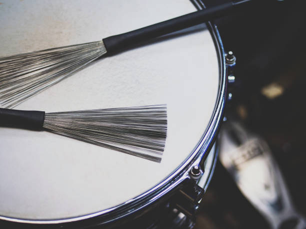 close up drum with drumsticks on black background