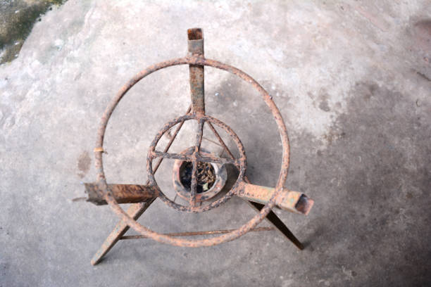 istock iron stand with earthen cooker  on cement ground 815762118