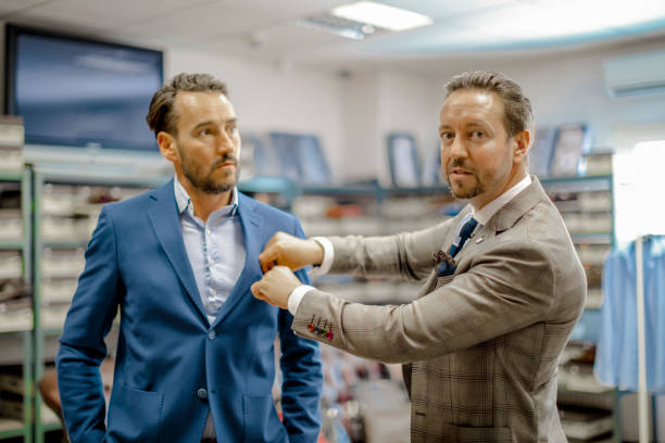 istock A personal stylist helping his customer 815767184