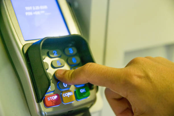 istock Person Using Keypad Atm Machine To Withdraw Money 815767232