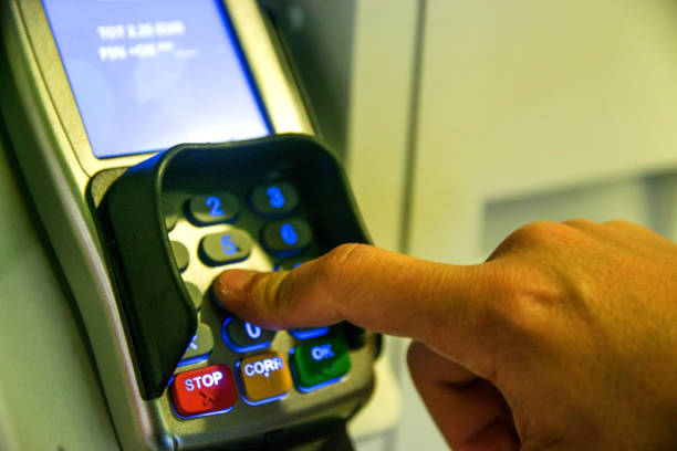 istock Person Using Keypad Atm Machine To Withdraw Money 815767662