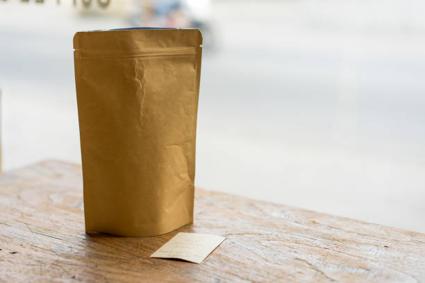 istock Brown paper bag on a wooden desk, Selective focus. 815778732
