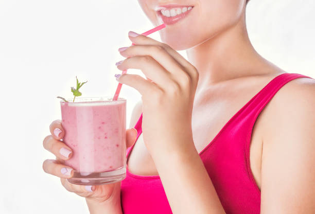 istock Woman drinks strawberry smoothie 815779382