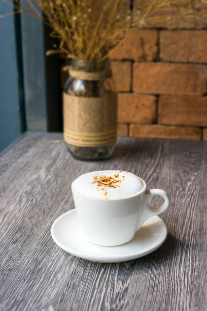 istock hot cappuccino on wood board 815781744