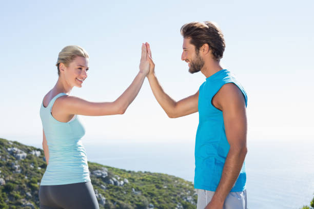 istock Fit couple standing high fiving 815783366