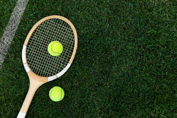 retro tennis racket on natural grass with balls. top view with copy space retro tennis racket on natural grass with balls. top view with copy space wimbledon stock pictures, royalty-free photos & images