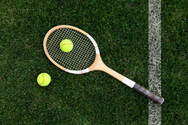istock retro tennis racket on natural grass with balls. top view 815783790