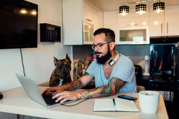 istock Man working at home with his dog next to him 815784014