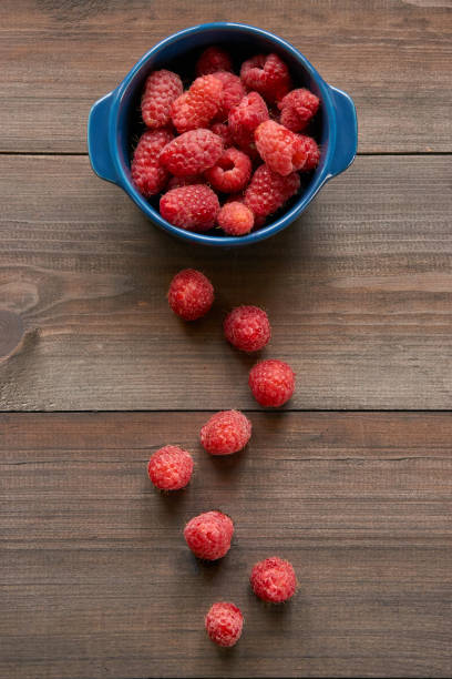 istock path made from raspberries to small ceramic bowl full of red raspberries 815798818
