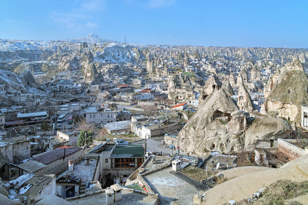 Goreme town in Cappadocia in winter, Turkey Goreme town in Cappadocia in winter, Turkey. In the background is visible the Uchisar Castle Rock in the mist. cappadocia winter photos stock pictures, royalty-free photos & images