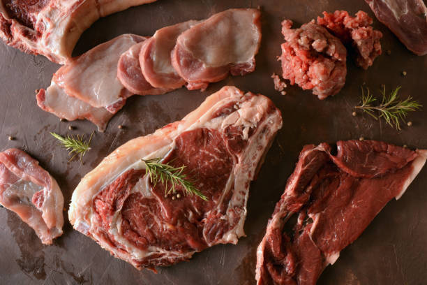 istock Raw meat accompanied by salt. pepper and Rosemary. 815833688