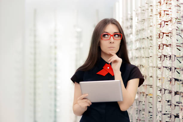 istock Undecided Woman with PC Tablet in Optical Store 815859462
