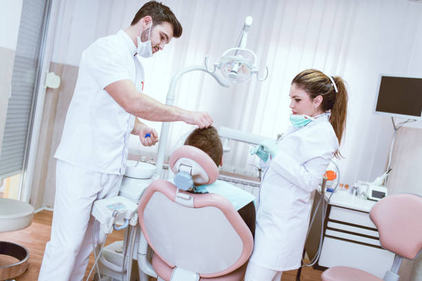istock Dentist Doctor And Young Nurse Checkign Patinent Before Surgery 815859474