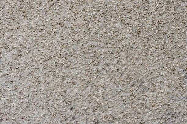 istock Plastered wall with gravel stones 815862374