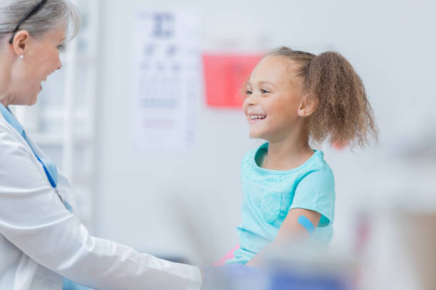 istock Cheerful doctor examines young female patient 815873270