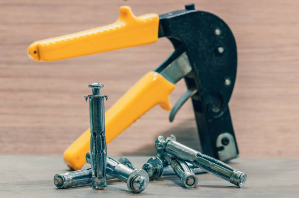 Ratchet wrench with hexagonal socket which was inserted via a gimbal joint adapter and the same several interchangeable sockets different sizes on a blue surface
