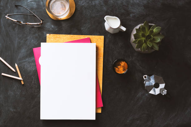 Flat lay blackboard desktop with white blank magazine