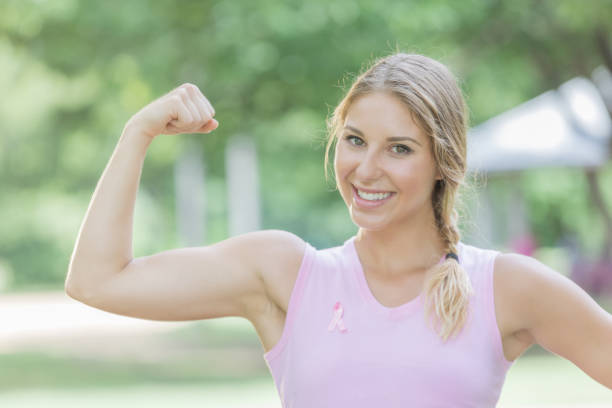 istock Breast cancer survivor flexes muscles 815907208