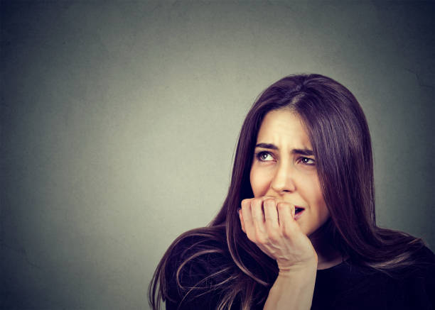 istock nervous woman biting her fingernails anxious 815909524