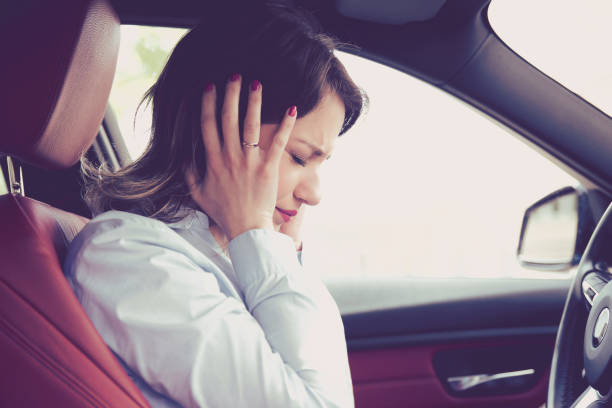 Stressed woman driver sitting inside her car stock photo