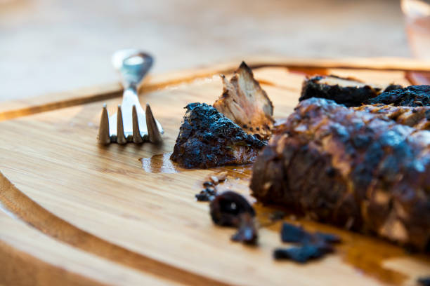 Roast Pork Tenderloin Sliced on a Wooden Cutting Board stock photo