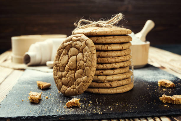 istock Biscuit sweet cookie background. Domestic stacked butter biscuit pattern concept,close up macro.Homemade cookies on wooden table.Cereal biscuits with the sesame,peanuts,sunflower and amaranth. 815915666