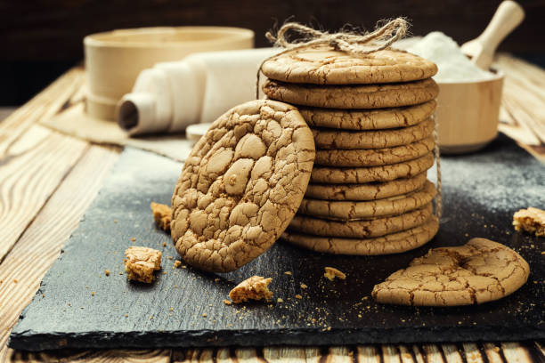 istock Biscuit sweet cookie background. Domestic stacked butter biscuit pattern concept,close up macro.Homemade cookies on wooden table.Cereal biscuits with the sesame,peanuts,sunflower and amaranth. 815915926