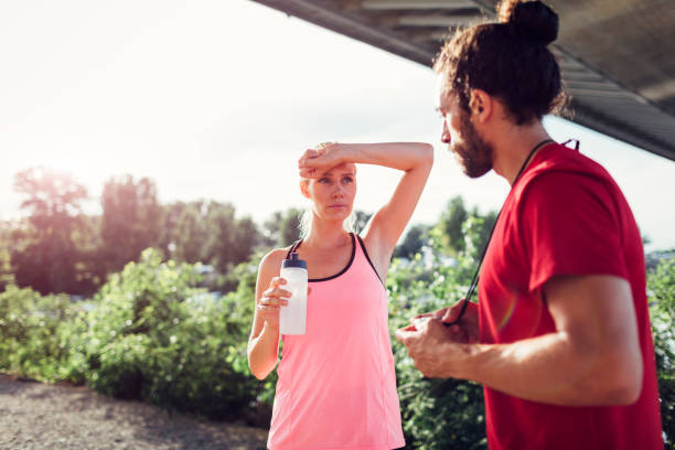 istock Woman Exercising With Personal Trainer Outdoors 815925096