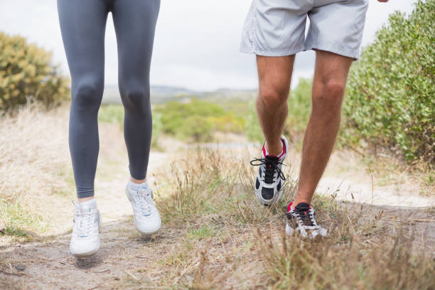 istock Fit couple jogging on mountain trail 815925222
