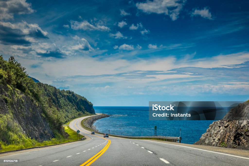 Right by the Saint Lawrence river, a look at beautiful Quebec Route 132, near Cap-au Renard (La Martre) in Haute-Gaspésie, situated in the Eastern part of the Canadian province. Travel photography. Road Stock Photo