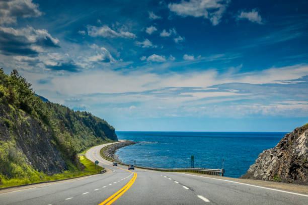 Right by the Saint Lawrence river, a look at beautiful Quebec Route 132, near Cap-au Renard (La Martre) in Haute-Gaspésie, situated in the Eastern part of the Canadian province. Travel photography. gulf of st lawrence photos stock pictures, royalty-free photos & images