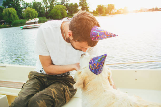 istock young man with dog,birthday party 815931796