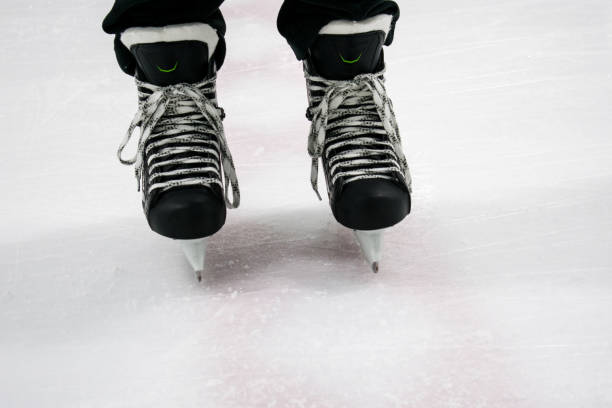 istock Hockey skates on ice rink 815939054