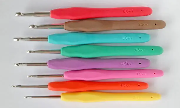 A crochet hook (or crochet needle) is an implement used to make loops in thread or yarn and to interlock them into crochet stitches.