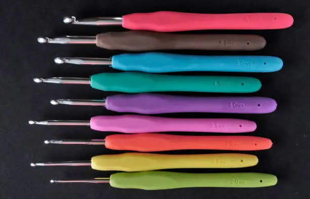 A crochet hook (or crochet needle) is an implement used to make loops in thread or yarn and to interlock them into crochet stitches.