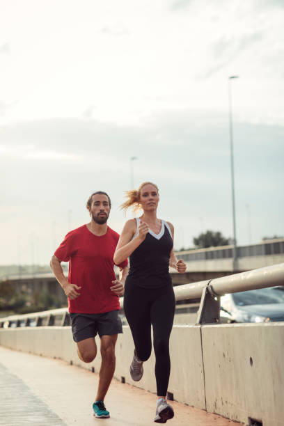 istock Woman Exercising With Personal Trainer Outdoors 815939384