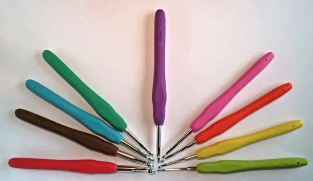 A crochet hook (or crochet needle) is an implement used to make loops in thread or yarn and to interlock them into crochet stitches.