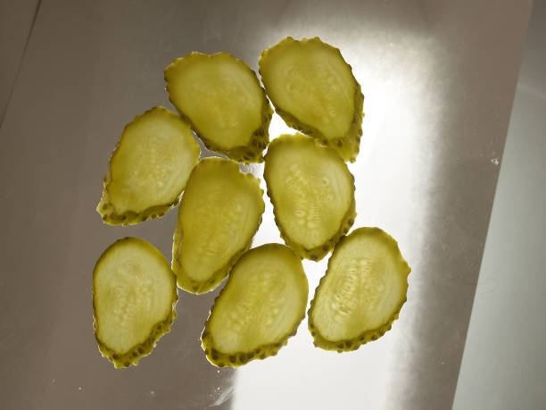 Semitransparent slices of pickled cucumbers stock photo