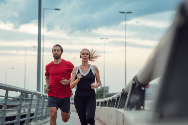 istock Woman Exercising With Personal Trainer Outdoors 815941920