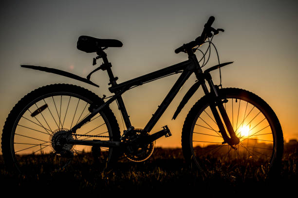 istock Silhouette of mountain bicycle on the sunset background. 815957652