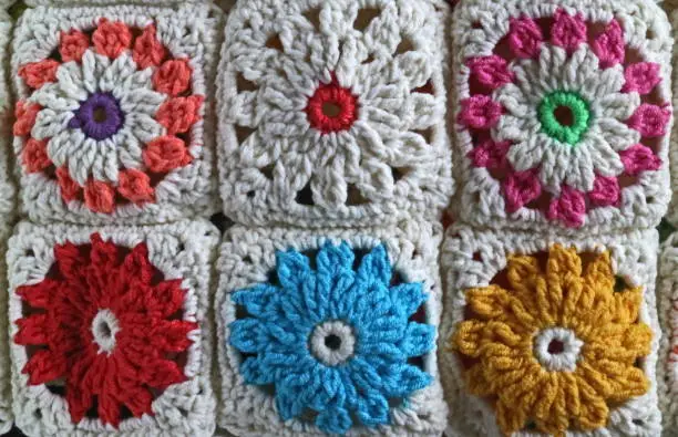 Crochet is a process of creating fabric by interlocking loops of yarn, thread, or strands of other materials using a crochet hook.