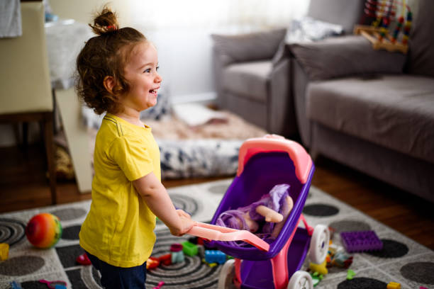 Little girl with doll in a stroller