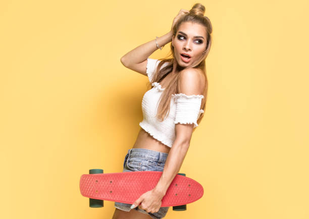 istock Trendy young girl with skateboard. 815960334