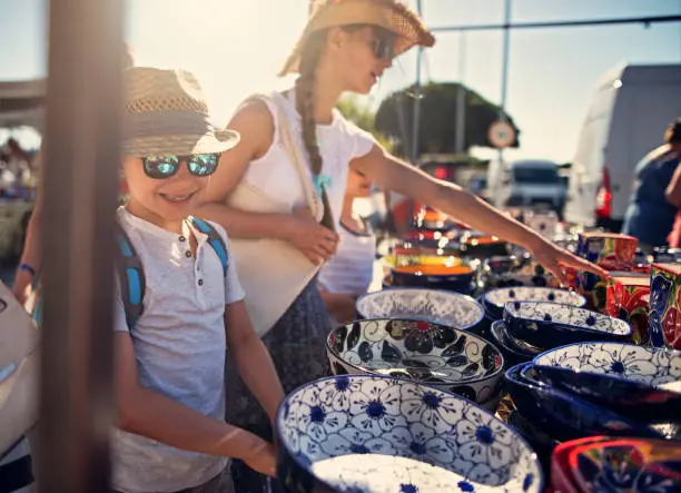 Photo of Kids buying souvenirs on flea market in Andalusia, Spain